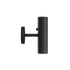 Svart cylindrisk vägglampa från sackit med arkitektonisk form och riktat ljus för korridor eller sänggavel i en modern nordisk interiör