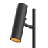 Svart cylindrisk lampa från sackit med riktbart lamphuvud och varmt orange ljus mot svart bakgrund i stilren nordisk design